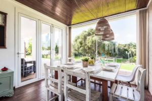 a dining room with a table and a large window at Bell Veure in Ciutadella