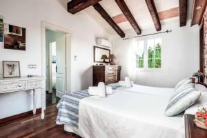a white bedroom with a bed and a window at Bell Veure in Ciutadella +27 photos