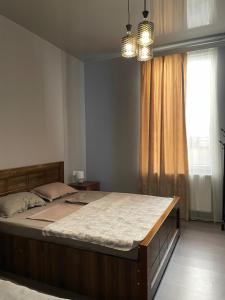 a bedroom with a large bed and a window at Hotel Lumi in Zugdidi +6 photos