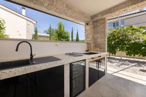 a kitchen with a sink and a counter top at Villa Divina in Milohnići