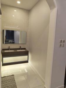 a bathroom with a sink and a mirror at شقة بغرفة نوم وصالة - Luxury bedroom and living Room in Jeddah