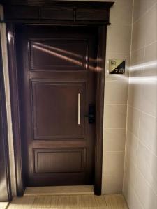 a brown door in a bathroom with a shower at شقة بغرفة نوم وصالة - Luxury bedroom and living Room in Jeddah +4 photos
