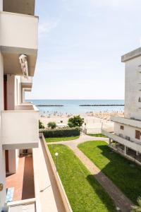 a view of the beach from the balcony of a building at Accesso al mare, residence perseo in Lido Adriano
