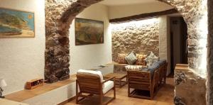 a room with a table and two chairs and a couch at Santuari de Santa Maria de Montgrony in Gombreny