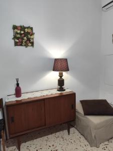 a lamp sitting on a table in a bedroom at My tiny house in Salerno