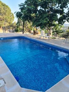 a large swimming pool with blue water at Sunset Paradise Villa Stroumpi in Stroumbi