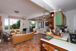 a kitchen and living room with a table and chairs at Villa Kate a Dreamy Summer Escape in Porto Heli
