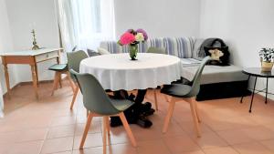 a living room with a table with a vase of flowers on it at Casa Maria in Porto Ceresio