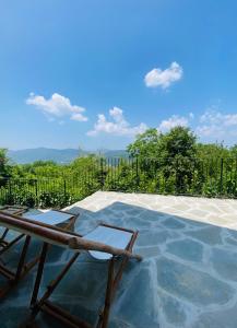 a patio with a table and a chair on top at Villa Angela - Ranza 55 in Lugnano