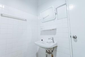 a white bathroom with a sink and a shower at X Stay On Maya Nimman - สเตย์ ออน เมญ่า นิมมาาน in Chiang Mai