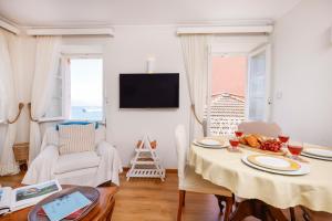 a living room with a table with food on it at Ruby's Gem Corfu in Corfu
