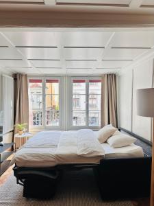a bedroom with a large bed in front of a window at central bijou in Thun