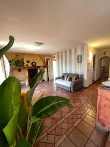 a living room with a couch and a table at Regina del Lago in San Michele +19 photos