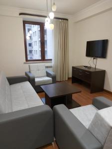 a living room with a couch and a table at Pink Yerevan apartments in Yerevan