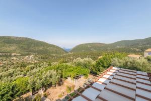 an overhead view of a roof with mountains in the background at Odyssey's Palace - Escape in Mythical Ithaca in Platithriás