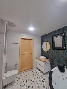 a bathroom with a tub and a toilet and a sink at Green Hill in Batumi
