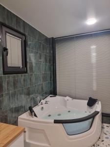 a bathroom with a bath tub in a room at Green Hill in Batumi +52 photos