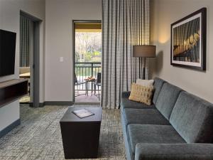 a living room with a couch and a television at Embassy Suites By Hilton Gatlinburg Resort in Gatlinburg