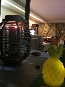 a table with a vase and a lemon on it at Fenix Villa in Noicattaro