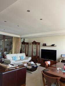 a living room with a couch and a table at Fenix Villa in Noicattaro