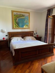 a bedroom with a large bed with a painting on the wall at Fenix Villa in Noicattaro