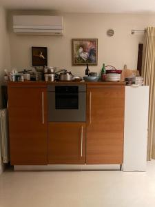 a kitchen with a stove and a refrigerator at Fenix Villa in Noicattaro