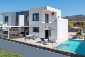 a villa with a swimming pool and a house at Villa Vasaltis & Selestitis in Gennadi