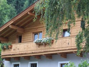 a balcony on a house with flowers on it at Modern Apartment in Kitzbuhel near Ski Area in Kitzbühel