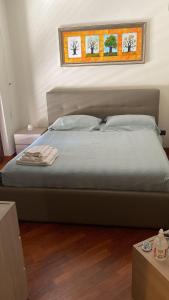 a bedroom with a large bed with two windows at Fenix Villa in Noicattaro