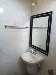 a white bathroom with a mirror and a sink at Lemony Pool Villa - Hua Hin in Ban Thap Tai (1)