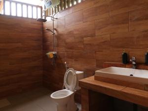 a bathroom with a toilet and a sink at Private Home in Jatiluwih