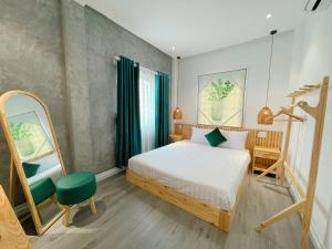 a bedroom with a bed and a green chair at PuLin Homestay in Thôn Dương Xuân Hạ +10 photos