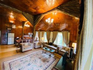 a living room with a couch and a table at Bilour House Main Dunga Gali Bazar, nathiagali in Dunga Gali