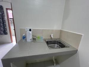 a kitchen counter with a sink and a mixer at Bilik 3 Katil Single Aircond Pekan in Pekan