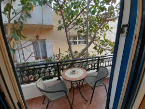 a patio with a table and chairs on a balcony at Studios Eftichia in Fourni Ikarias +12 photos