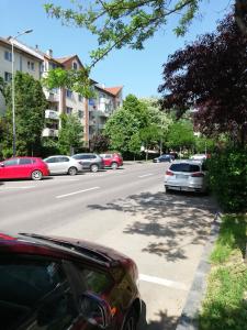 a street with cars parked on the side of the road at KM Art Apartman in Sfântu-Gheorghe
