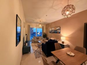 a living room with a couch and a table at Stunning Park View 1Bhk 4pax in Dubai