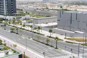 una vista aérea de una autopista con un edificio en StayShort - Cozy Studio in Azizi Riviera Sleeps 3 with Pool, en Dubái