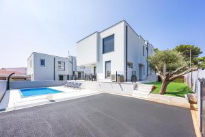 an exterior view of a house with a swimming pool at Peninsula Villas in Premantura