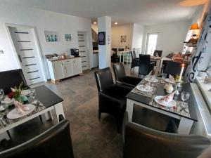 a dining room with a table and chairs and a kitchen at Monato in Poprad
