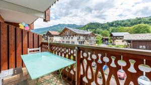 ein Balkon mit einem blauen Tisch auf einem Holzgeländer in der Unterkunft Hermine 1 N09 - 2P4 in Morillon + 3 Fotos
