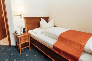 Postel nebo postele na pokoji v ubytování Hotel Reindl Suiten & Appartments