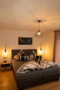 a bedroom with a bed and a light at Zimmer by Appartement Sporer in Hippach in Hippach