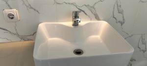 a white sink with a faucet in a bathroom at Full Moon Home Stay in Canggu
