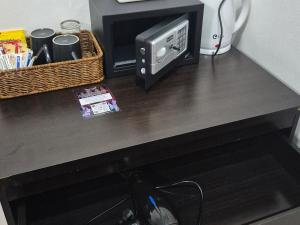 a counter top with a microwave and a computer on it at Dorothys in Pattaya South