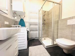 a bathroom with a shower and a toilet and a sink at 123 Apartment Graz - top 1 in Graz +21 photos