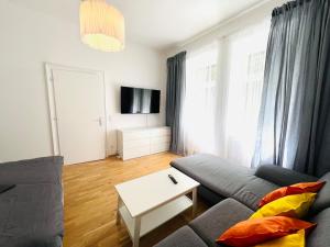 a living room with a couch and a table at 123 Apartment Graz - top 1 in Graz