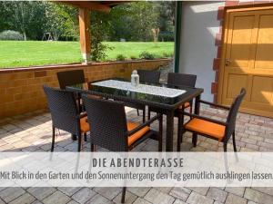 a patio with a black table and chairs at Familien Appartement „Im Landhaus“ in Gaal