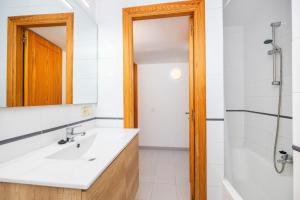 a bathroom with a sink and a tub and a mirror at Can Vidal Cabrera in Ses Salines +19 photos