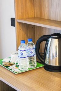 two bottles of water are sitting on a shelf at Nature Rock Ella in Ella